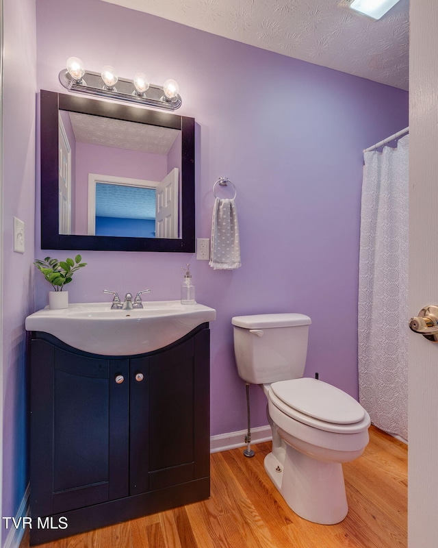 516 Bowmantown Rd, Telford, TN 37690 - bathroom with wood finished floors, vanity, toilet, and baseboards