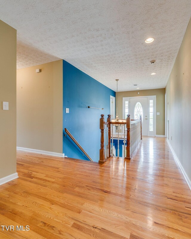 516 Bowmantown Rd, Telford, TN 37690 - unfurnished room with light wood-type flooring, baseboards, a textured ceiling, and recessed lighting