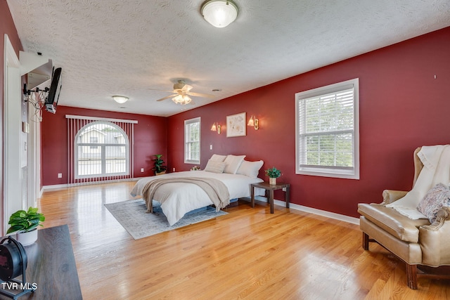 516 Bowmantown Rd, Telford, TN 37690 - bedroom featuring a textured ceiling, wood finished floors, and baseboards