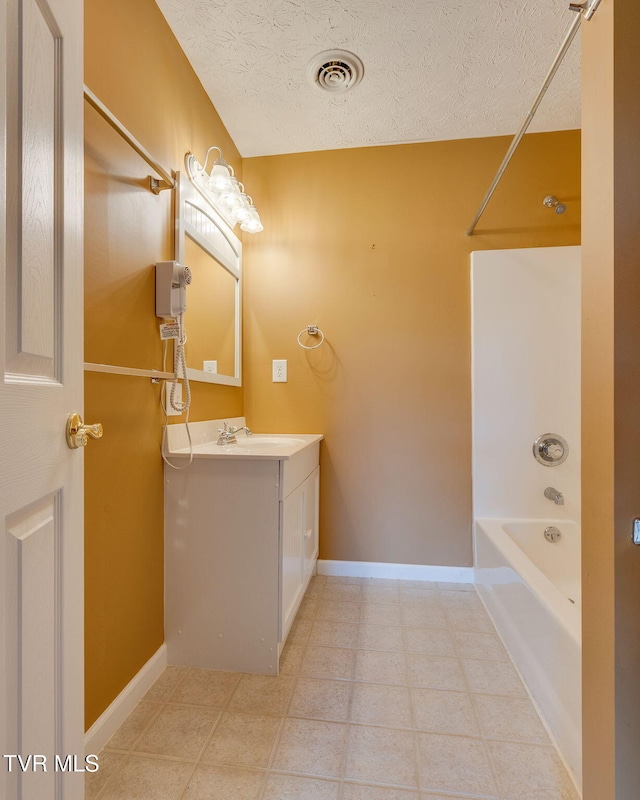 516 Bowmantown Rd, Telford, TN 37690 - bathroom featuring vanity, washtub / shower combination, a textured ceiling, and baseboards