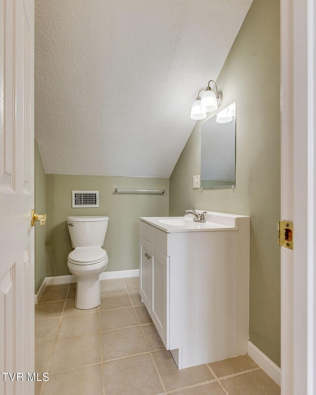 516 Bowmantown Rd, Telford, TN 37690 - half bathroom featuring a textured ceiling, vanity, toilet, baseboards, and tile patterned floors