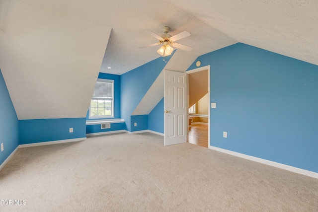 516 Bowmantown Rd, Telford, TN 37690 - additional living space with vaulted ceiling, carpet flooring, ceiling fan, baseboards, and a textured ceiling