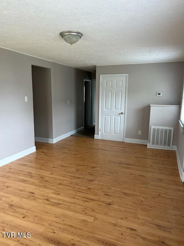 1657 Redwood Dr, Kingsport, TN 37664 - spare room with a textured ceiling, light wood-type flooring, and baseboards
