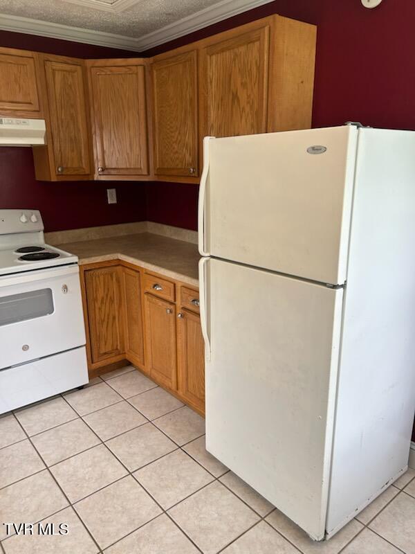 1657 Redwood Dr, Kingsport, TN 37664 - kitchen featuring white appliances, extractor fan, light tile patterned floors, brown cabinetry, and light countertops