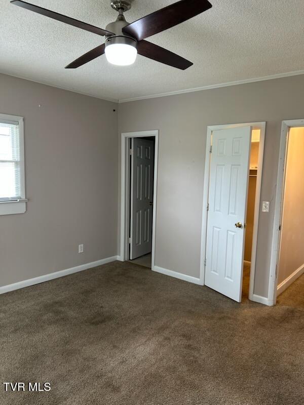 1657 Redwood Dr, Kingsport, TN 37664 - unfurnished bedroom featuring a textured ceiling, carpet, ornamental molding, baseboards, and ceiling fan