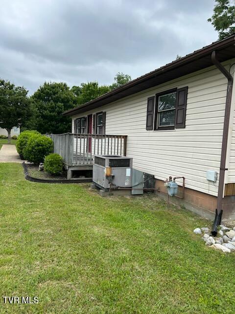 1657 Redwood Dr, Kingsport, TN 37664 - view of side of property with cooling unit, a deck, and a lawn