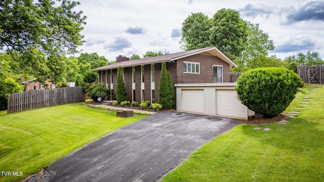 206 Windmere Pl, Kingsport, TN 37663 - split foyer home with driveway, a chimney, brick siding, and an attached garage