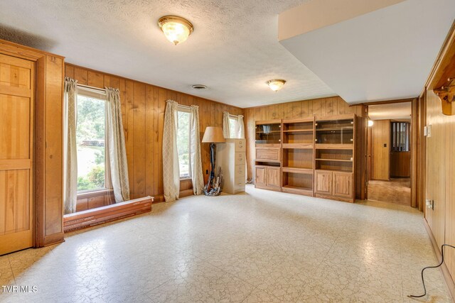 206 Windmere Pl, Kingsport, TN 37663 - unfurnished living room featuring wood walls and a textured ceiling