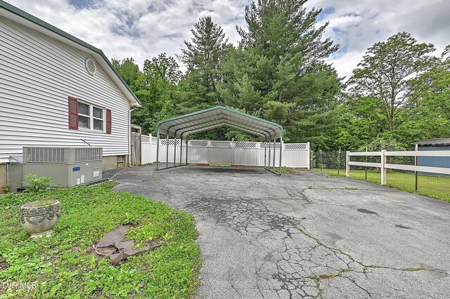 481 Pleasant Hill Rd, Blountville, TN 37617 - garage with asphalt driveway, a detached carport, and central AC unit
