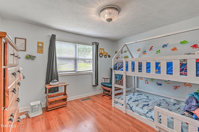 481 Pleasant Hill Rd, Blountville, TN 37617 - bedroom featuring a textured ceiling, light wood-style floors, and baseboards