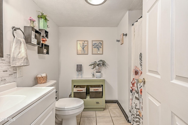 481 Pleasant Hill Rd, Blountville, TN 37617 - bathroom with toilet, vanity, a textured ceiling, tile patterned flooring, and decorative backsplash