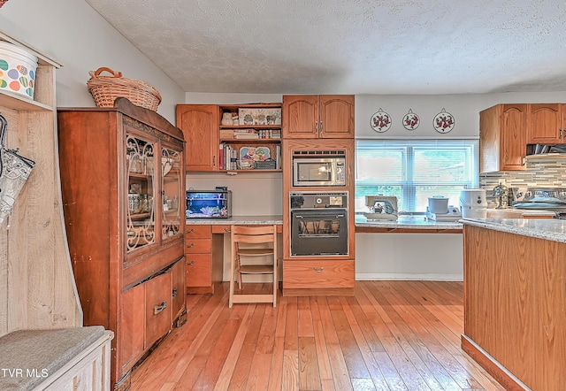 481 Pleasant Hill Rd, Blountville, TN 37617 - kitchen with black appliances, open shelves, brown cabinetry, range hood, and light wood-type flooring