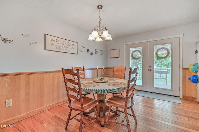481 Pleasant Hill Rd, Blountville, TN 37617 - dining area with light wood-style floors, french doors, wainscoting, a chandelier, and wooden walls