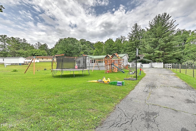 481 Pleasant Hill Rd, Blountville, TN 37617 - view of front of home with a playground, a trampoline, view of scattered trees, and asphalt driveway