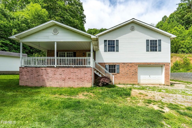 402 Crabtree Rd, Roan Mountain, TN 37687 - view of front facade with brick siding, an attached garage, a front lawn, and a porch