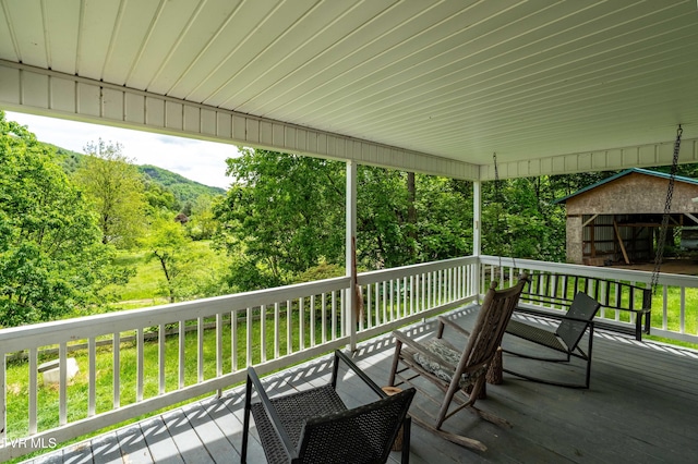 402 Crabtree Rd, Roan Mountain, TN 37687 - deck with a wooded view and an outbuilding