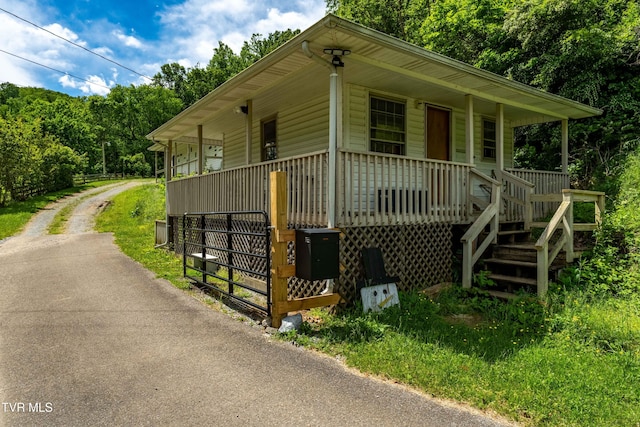 402 Crabtree Rd, Roan Mountain, TN 37687 - view of front of property with a porch, driveway, and stairs