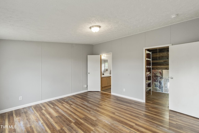 1830 Dover Rd, Morristown, TN 37813 - spare room with wood finished floors, a textured ceiling, a smoke detector, and baseboards
