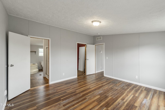 1830 Dover Rd, Morristown, TN 37813 - unfurnished bedroom featuring wood finished floors, a textured ceiling, ensuite bath, and baseboards