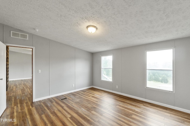 1830 Dover Rd, Morristown, TN 37813 - empty room with wood finished floors, a textured ceiling, and baseboards