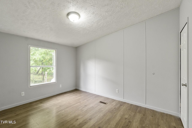 1830 Dover Rd, Morristown, TN 37813 - unfurnished room with wood finished floors, a textured ceiling, and baseboards