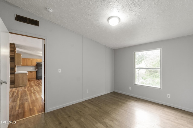 1830 Dover Rd, Morristown, TN 37813 - unfurnished room featuring a textured ceiling, light wood-style flooring, and baseboards