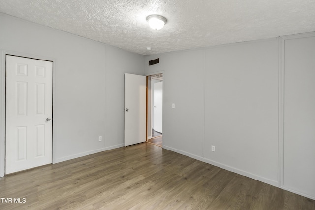 1830 Dover Rd, Morristown, TN 37813 - unfurnished bedroom with a textured ceiling and wood finished floors