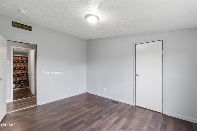 1830 Dover Rd, Morristown, TN 37813 - unfurnished bedroom featuring dark wood-style floors and a textured ceiling