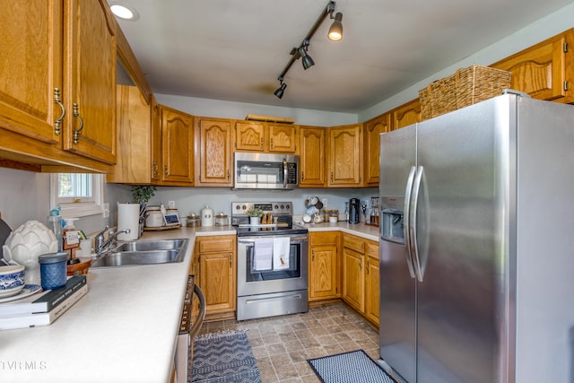 595 Suncrest Dr, Bristol, VA 24201 - kitchen featuring appliances with stainless steel finishes, a sink, brown cabinetry, and light countertops
