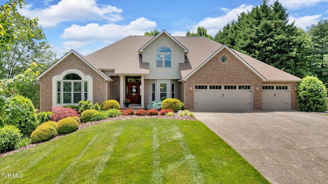 5 Carriage Ct, Johnson City, TN 37604 - view of front of home with brick siding, an attached garage, concrete driveway, and a front yard