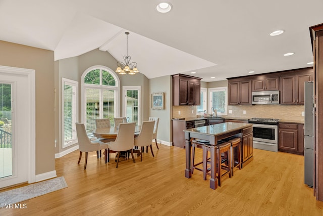 5 Carriage Ct, Johnson City, TN 37604 - kitchen with appliances with stainless steel finishes, plenty of natural light, decorative backsplash, a chandelier, and vaulted ceiling