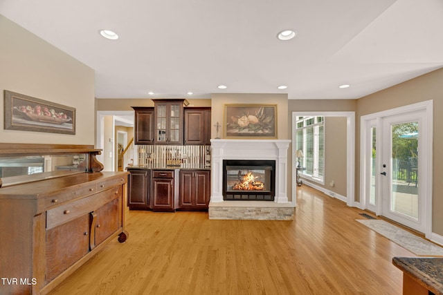 5 Carriage Ct, Johnson City, TN 37604 - living room featuring light wood-style flooring, a glass covered fireplace, recessed lighting, stairs, and baseboards