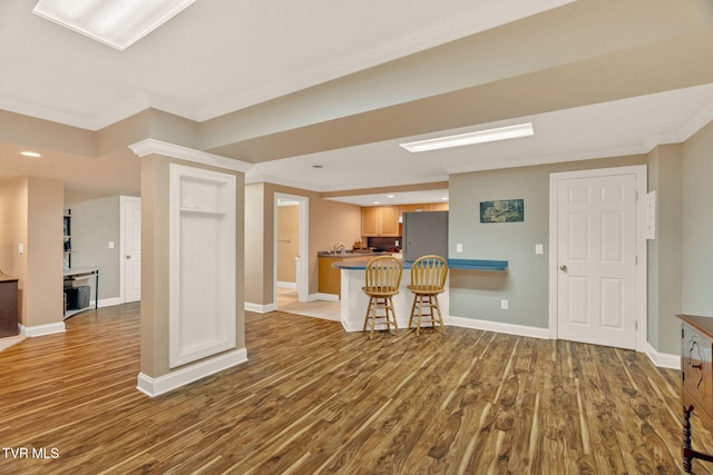 5 Carriage Ct, Johnson City, TN 37604 - kitchen featuring freestanding refrigerator, crown molding, wood finished floors, a breakfast bar area, and baseboards
