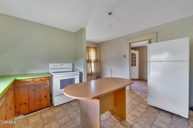 1217 Kentucky Ave, Bristol, TN 37620 - kitchen with white appliances, light countertops, stone finish floors, and a center island