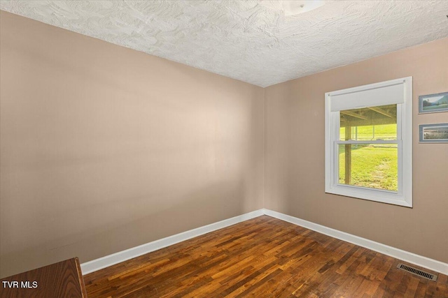 105 Meredith Dr, Elizabethton, TN 37643 - empty room featuring baseboards, dark wood-style flooring, and a textured ceiling