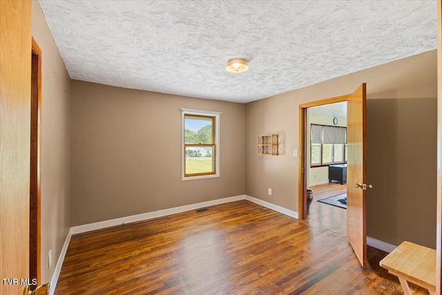 105 Meredith Dr, Elizabethton, TN 37643 - empty room with healthy amount of natural light, wood finished floors, baseboards, and a textured ceiling