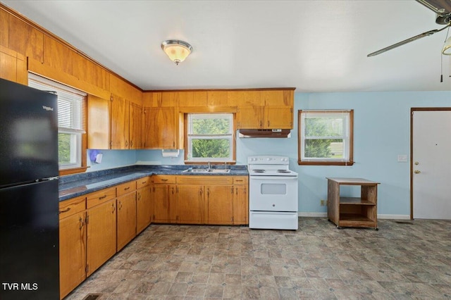 105 Meredith Dr, Elizabethton, TN 37643 - kitchen featuring freestanding refrigerator, white electric range oven, under cabinet range hood, a sink, and dark countertops