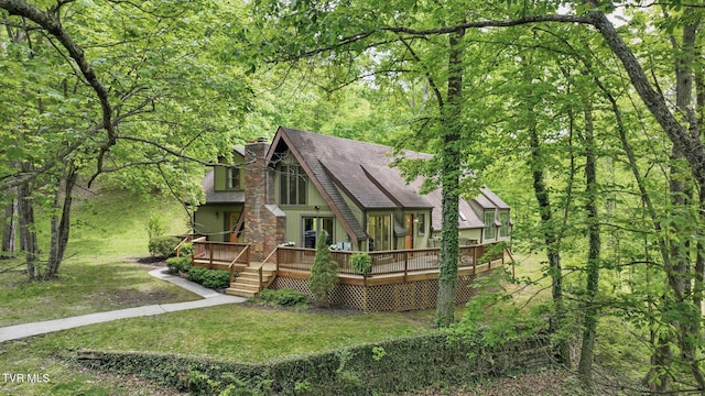 8466 Courtland Rd, Wise, VA 24293 - back of property with a chimney, a deck, roof with shingles, a yard, and a view of trees