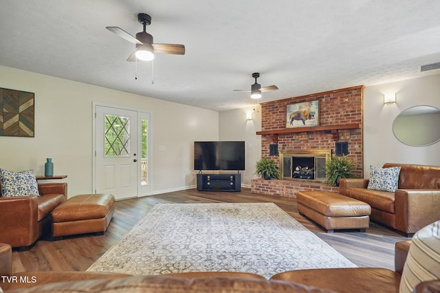 8466 Courtland Rd, Wise, VA 24293 - living area featuring ceiling fan, wood finished floors, a textured ceiling, baseboards, and a brick fireplace