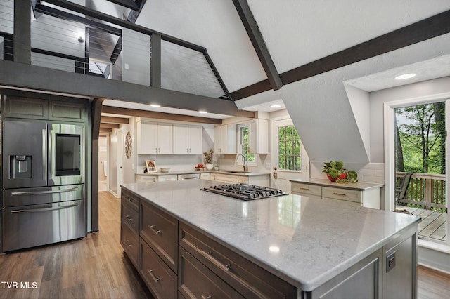 8466 Courtland Rd, Wise, VA 24293 - kitchen with stainless steel appliances, wood finished floors, a sink, beam ceiling, and light stone countertops