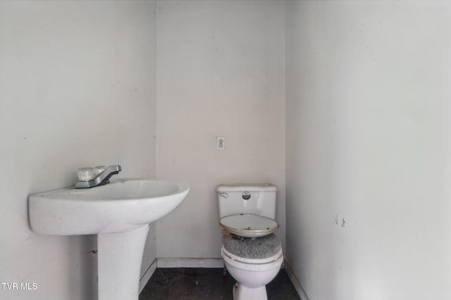 8466 Courtland Rd, Wise, VA 24293 - half bath featuring toilet, baseboards, and a sink