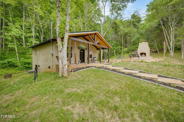 455 Okey Mowell Rd, Kingsport, TN 37660 - view of grassy yard featuring an outdoor fireplace and a wooded view