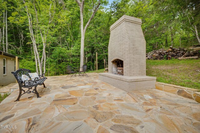 455 Okey Mowell Rd, Kingsport, TN 37660 - view of patio / terrace with an outdoor brick fireplace and a view of trees
