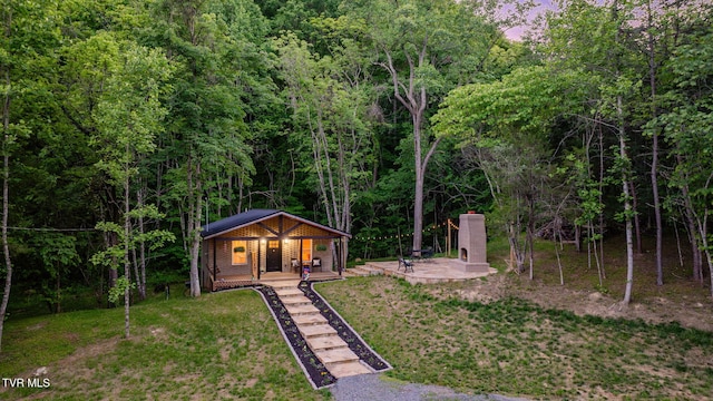 455 Okey Mowell Rd, Kingsport, TN 37660 - view of front of property with a view of trees, a front lawn, and covered porch