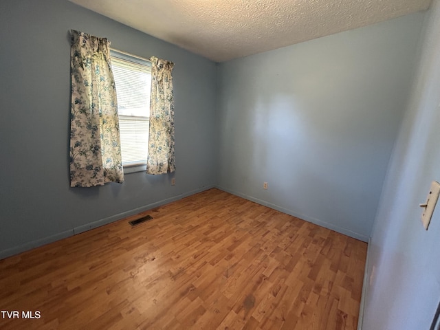 12139 Driffield Dr, Coeburn, VA 24230 - spare room featuring wood finished floors, a textured ceiling, and baseboards