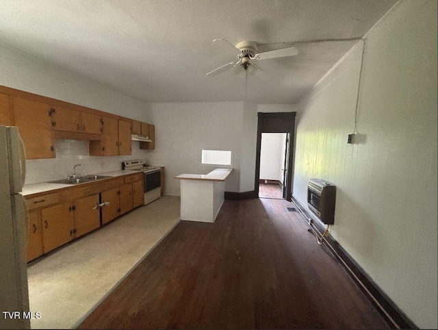 501 Moore St, Bristol, VA 24201 - kitchen with white appliances, heating unit, light countertops, under cabinet range hood, and a sink