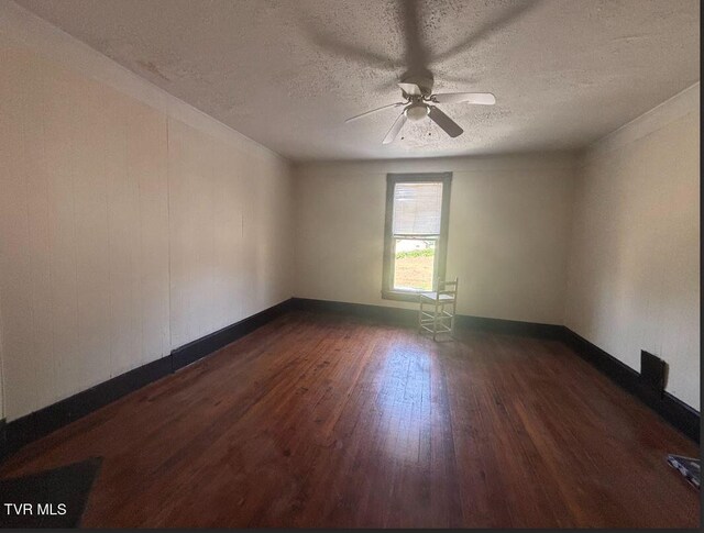 501 Moore St, Bristol, VA 24201 - spare room with dark wood finished floors, a textured ceiling, ceiling fan, and baseboards