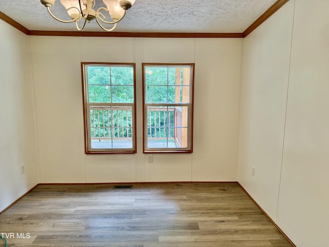 1761 Corby Bridge Rd, Chuckey, TN 37641 - spare room with a chandelier, a textured ceiling, ornamental molding, and wood finished floors