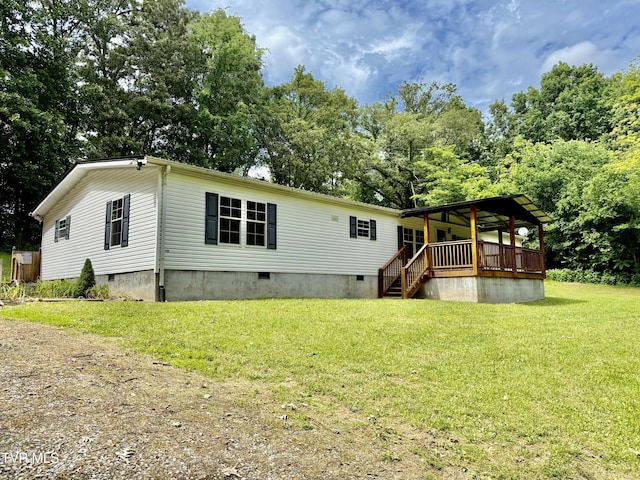 1761 Corby Bridge Rd, Chuckey, TN 37641 - back of property featuring crawl space, a lawn, view of wooded area, and a deck