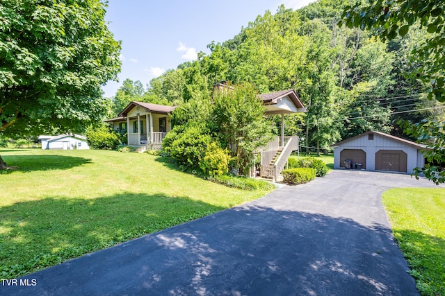 1605 Ryder Church Rd, Bluff City, TN 37618 - view of property hidden behind natural elements with covered porch, an outbuilding, a detached garage, stairs, and a front yard
